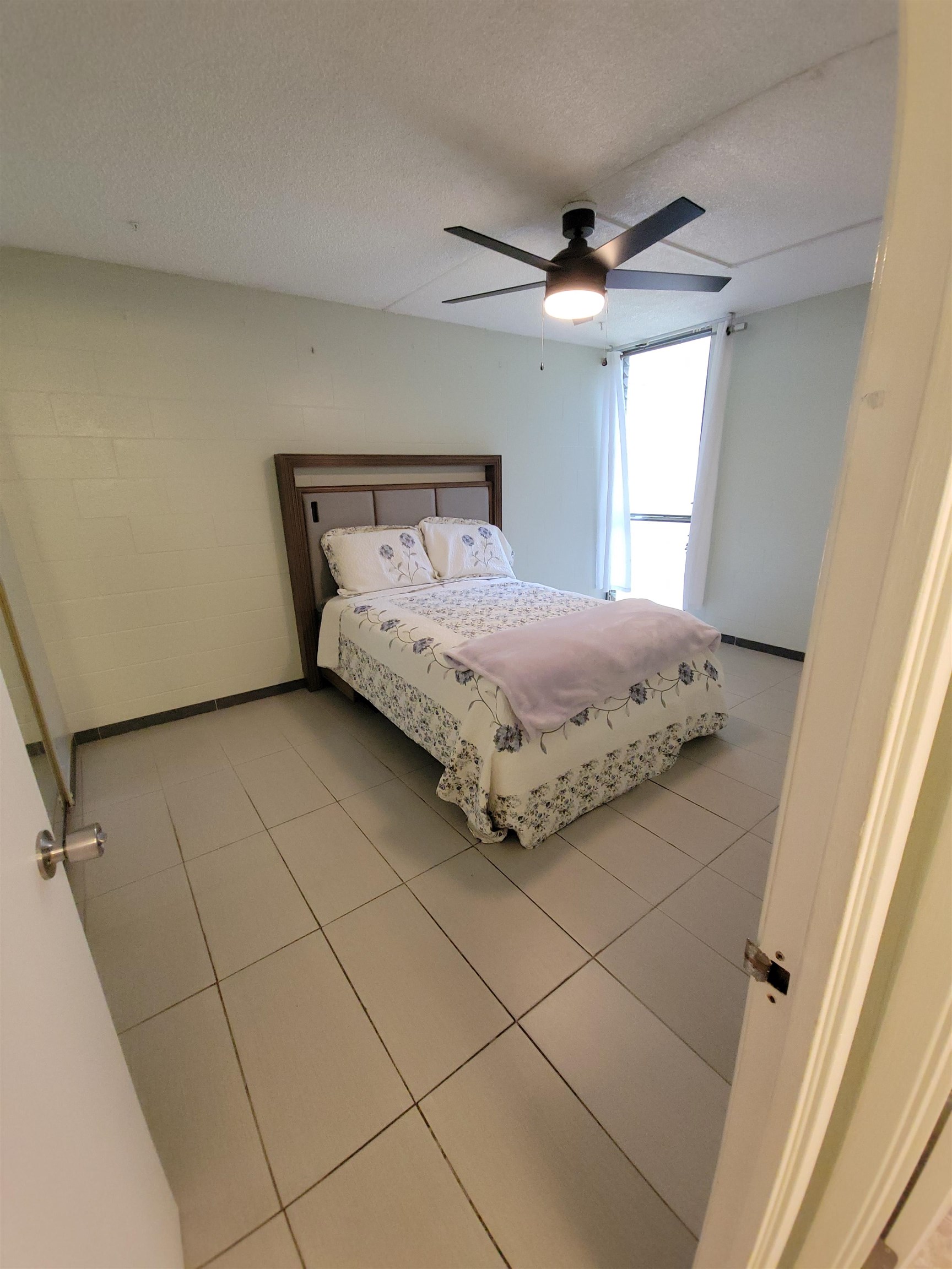 111 Kahului Beach Road, Unit B213 Kahului, HI 96732 - Photo 13 of 28 a bedroom with a bed and a window