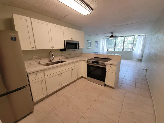a kitchen with a sink stove and cabinets