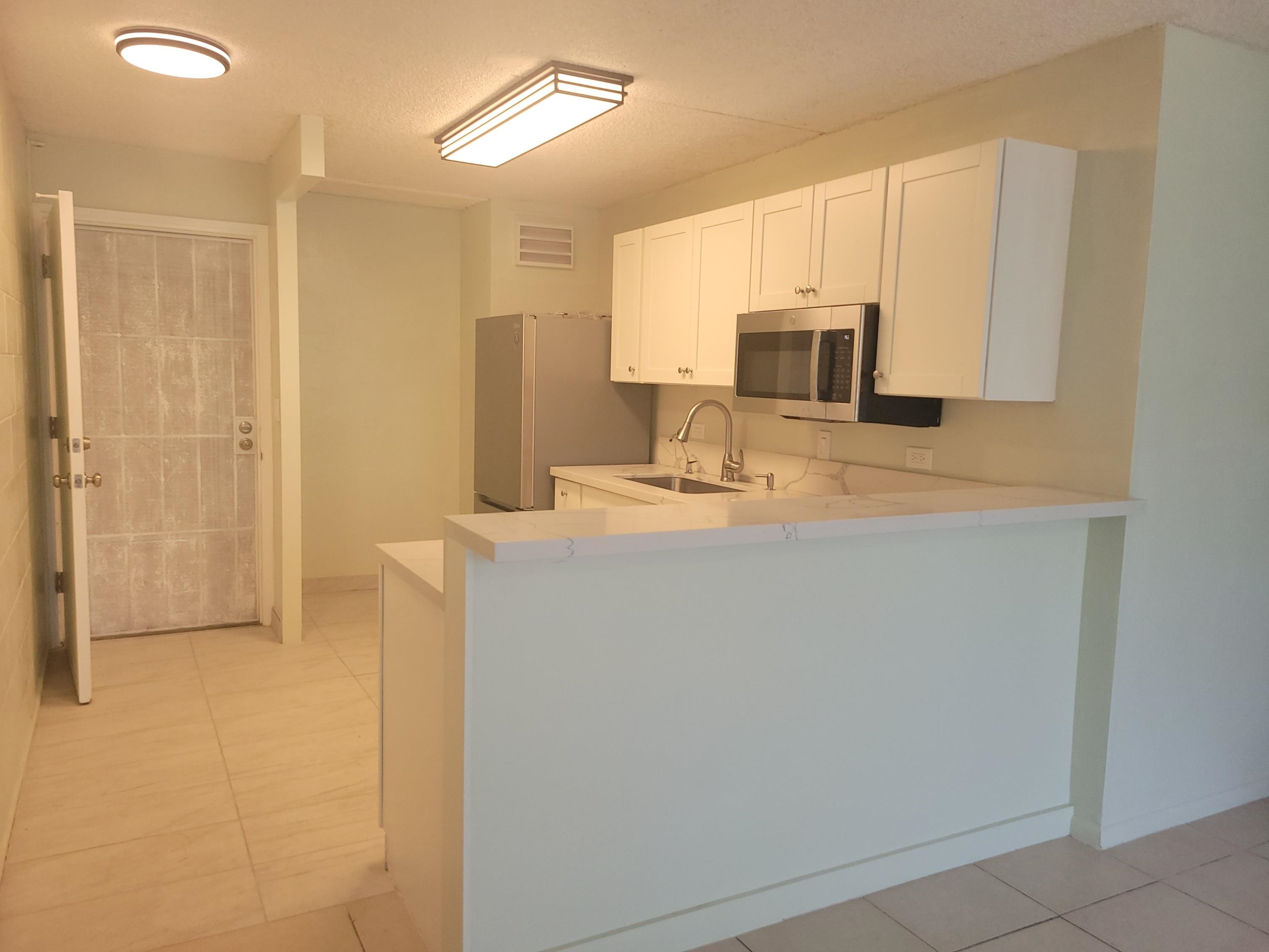 111 Kahului Beach Road, Unit B213 Kahului, HI 96732 - Photo 6 of 28 a bathroom with a sink a toilet and mirror