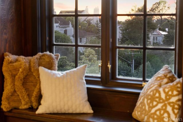 a living room with furniture and floor to ceiling windows