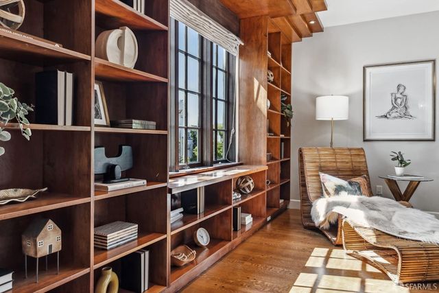 a living room with furniture and flowers