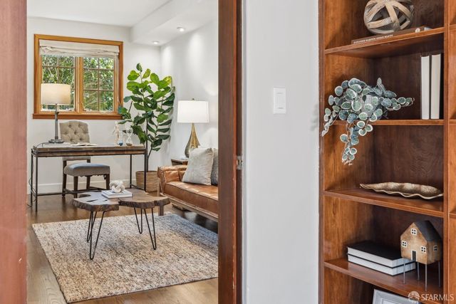 a living room with furniture and a potted plant