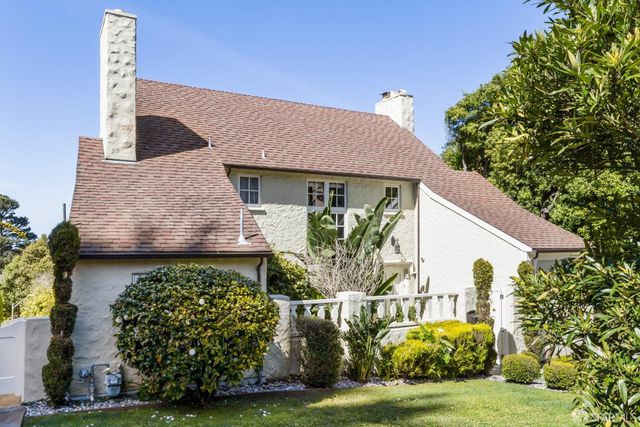 a front view of a house with garden