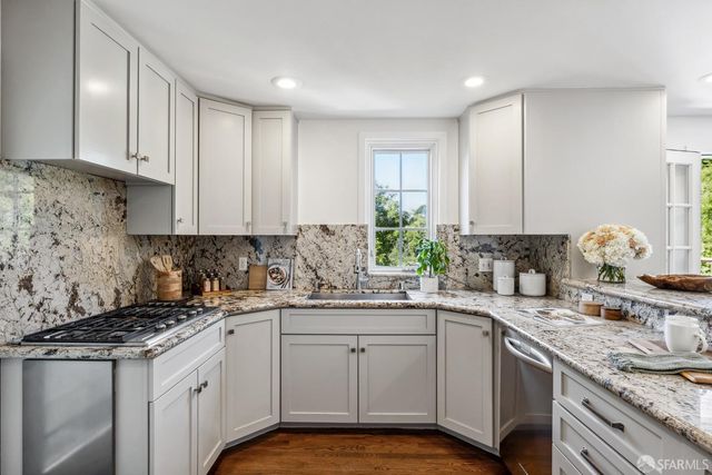 a spacious bedroom with a bed and a dresser next to a window