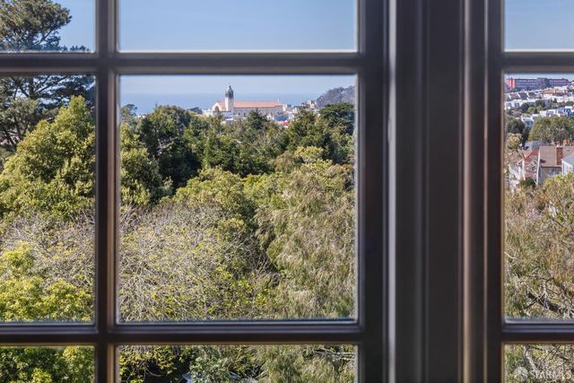 a front view of a house with a yard and fountain in middle