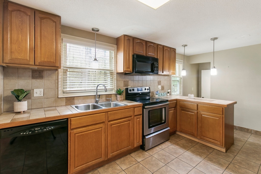 494 Tiffany Street Springfield, MA 01108 - Photo 12 of 40 a kitchen with a sink stove top oven and microwave