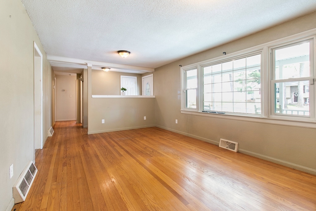 494 Tiffany Street Springfield, MA 01108 - Photo 16 of 40 a view of an empty room with wooden floor and a window