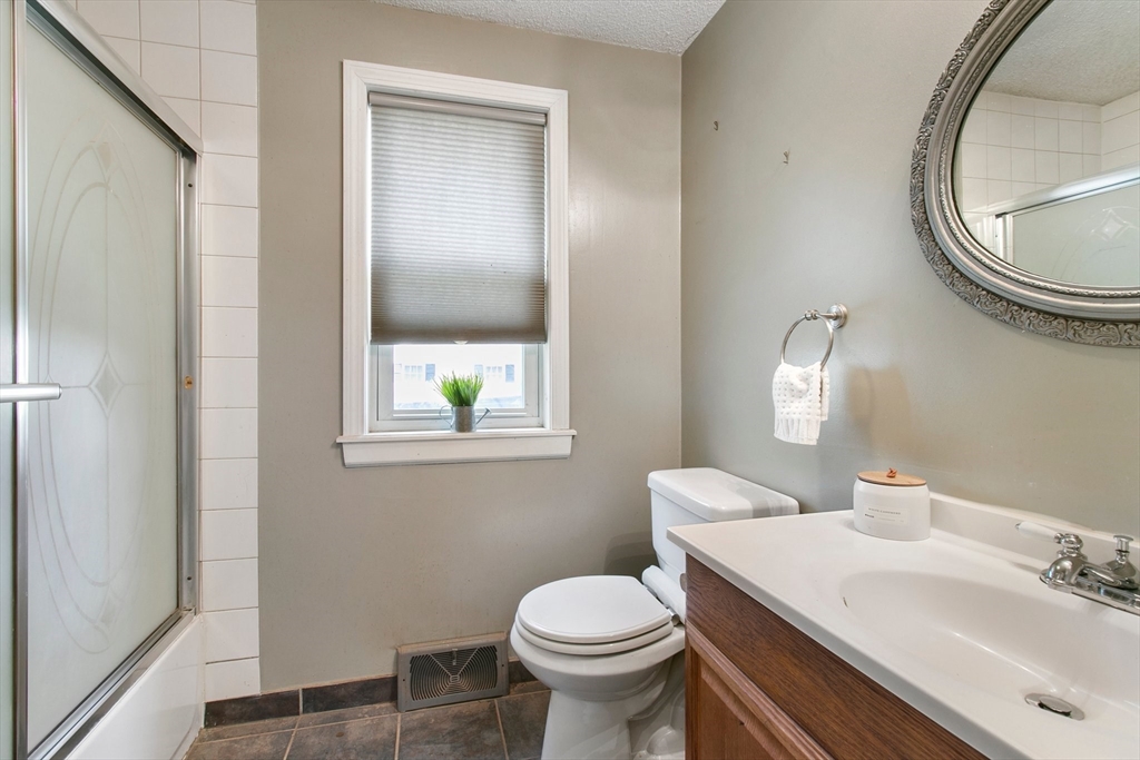 494 Tiffany Street Springfield, MA 01108 - Photo 18 of 40 a bathroom with a sink toilet and a mirror