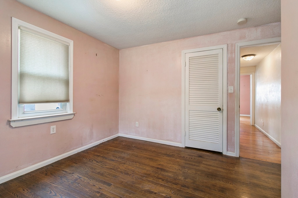 494 Tiffany Street Springfield, MA 01108 - Photo 22 of 40 an empty room with wooden floor and mirror
