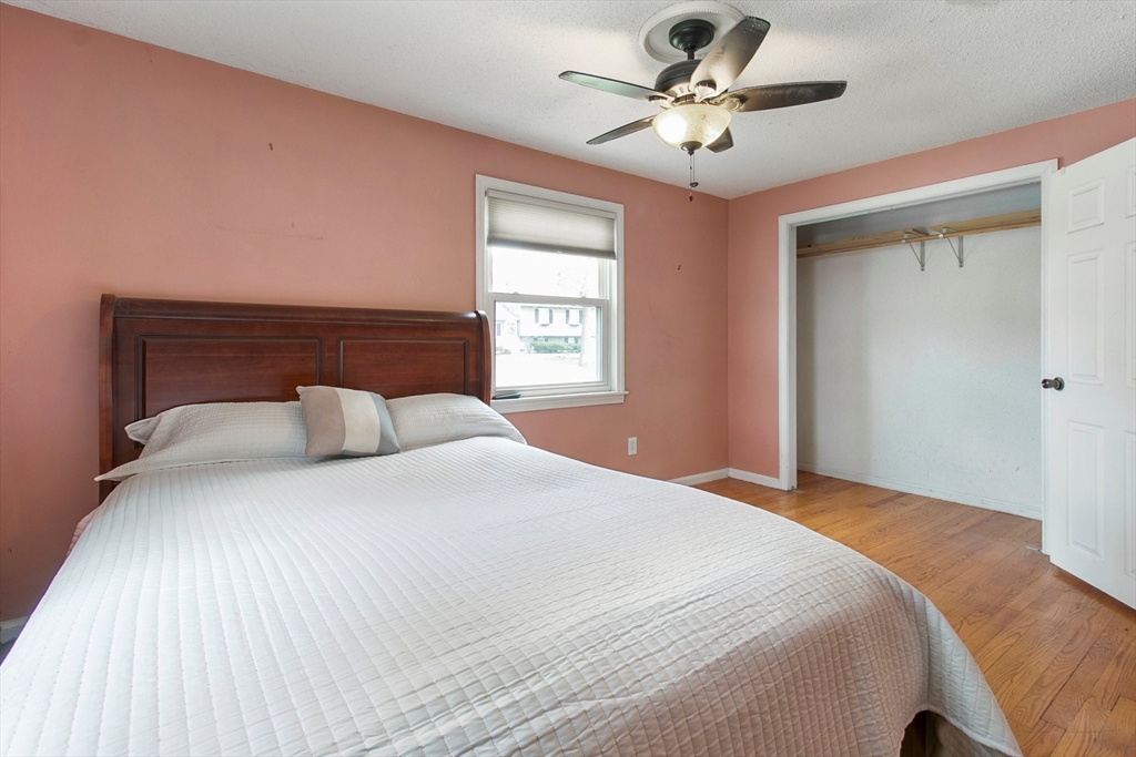 494 Tiffany Street Springfield, MA 01108 - Photo 25 of 40 a bedroom with a large bed and a chandelier