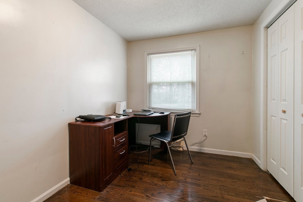 494 Tiffany Street Springfield, MA 01108 - Photo 26 of 40 a view of a workspace with furniture and a window