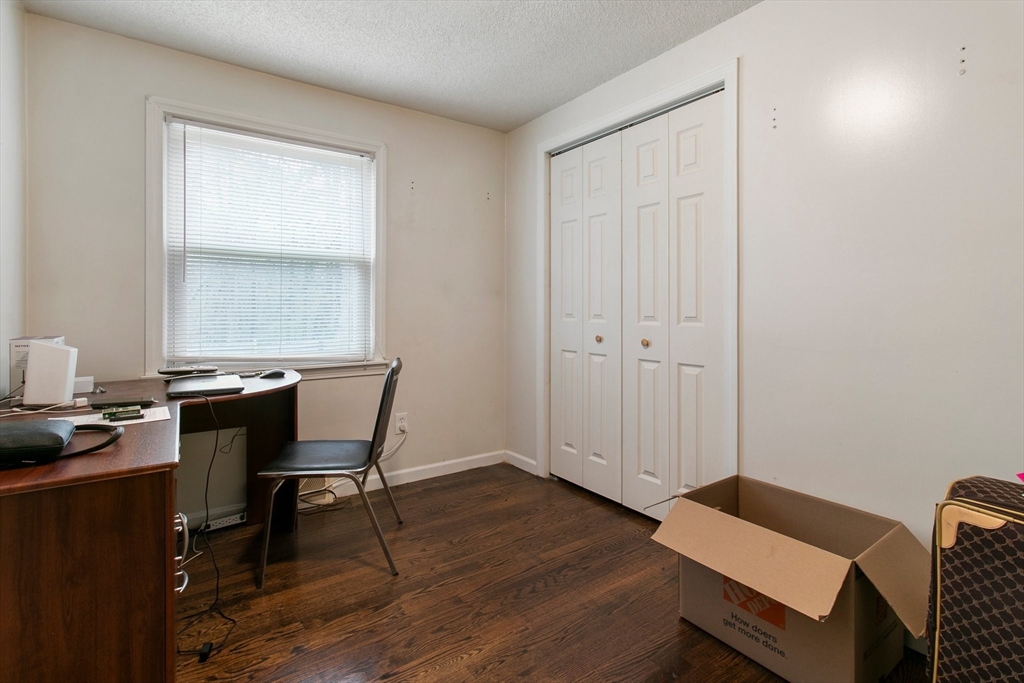 494 Tiffany Street Springfield, MA 01108 - Photo 27 of 40 a workspace with furniture and wooden floor