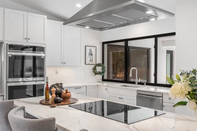 a bathroom with a granite countertop sink mirror vanity and toilet