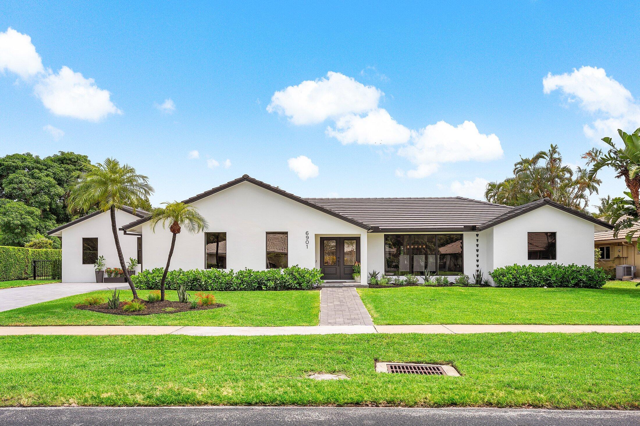 6901 Giralda Circle Boca Raton, FL 33433 - Photo 2 of 83 a front view of house with yard and green space