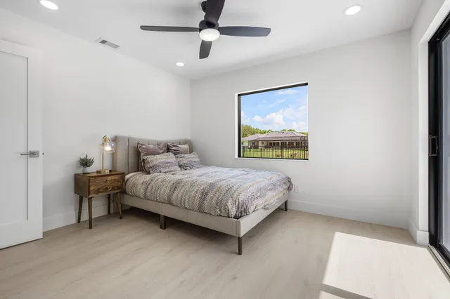 a bathroom with a granite countertop sink a toilet and a mirror