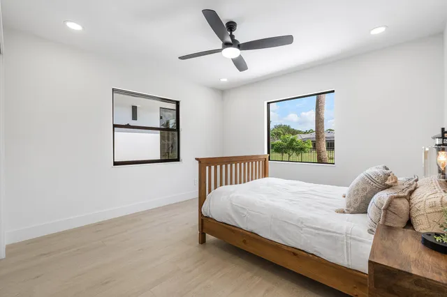 a bathroom with a granite countertop sink mirror and shower