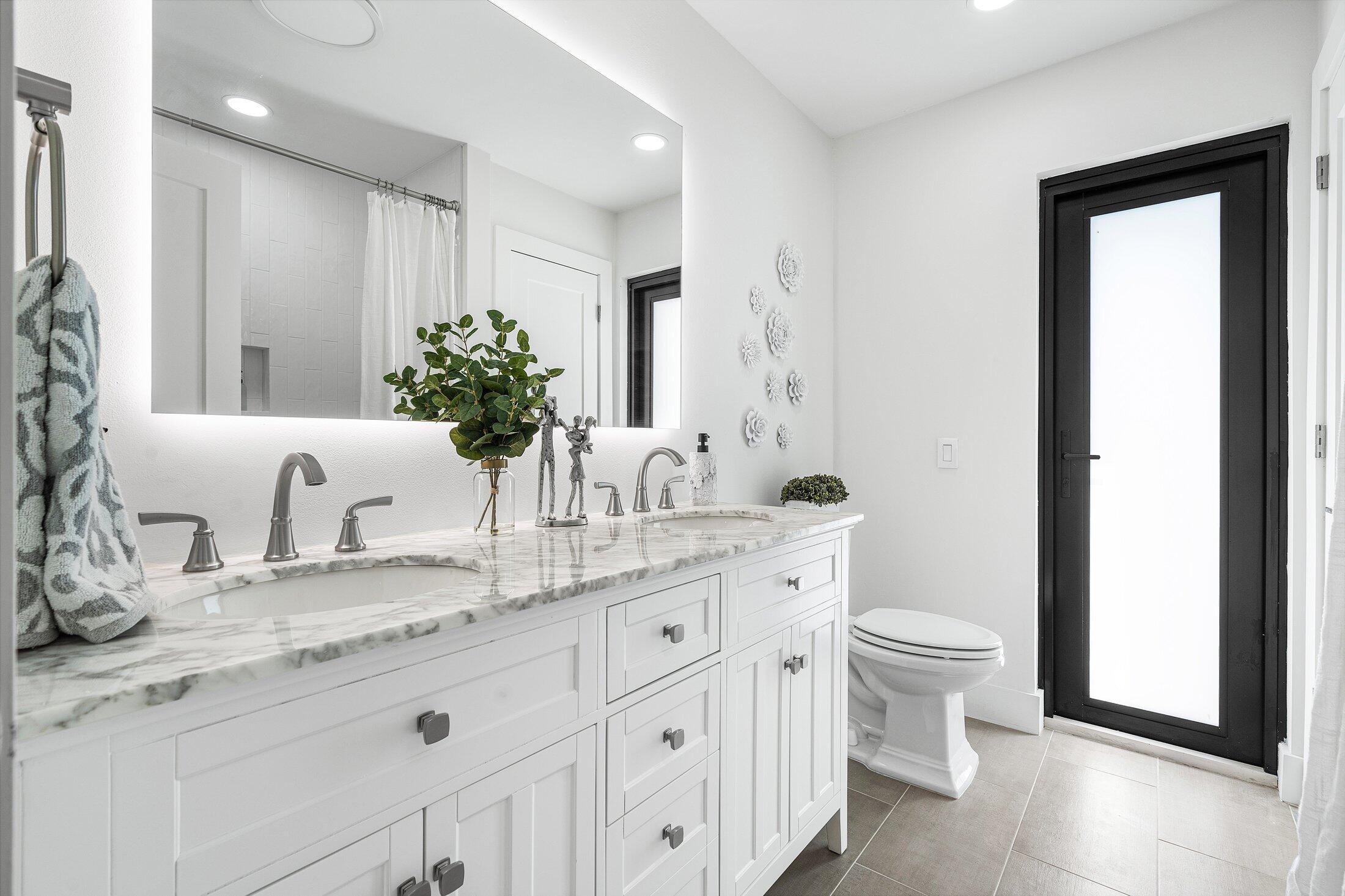 6901 Giralda Circle Boca Raton, FL 33433 - Photo 38 of 83 a bathroom with a granite countertop sink toilet and mirror