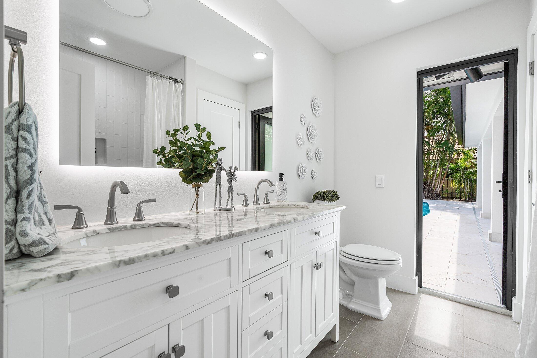 6901 Giralda Circle Boca Raton, FL 33433 - Photo 39 of 83 a bathroom with a granite countertop sink mirror vanity and toilet