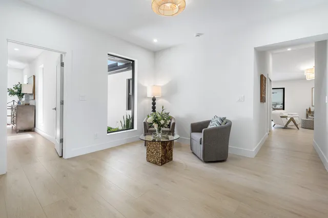 a front view of a house with a yard and potted plants