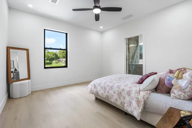 an aerial view of residential houses with outdoor space and trees