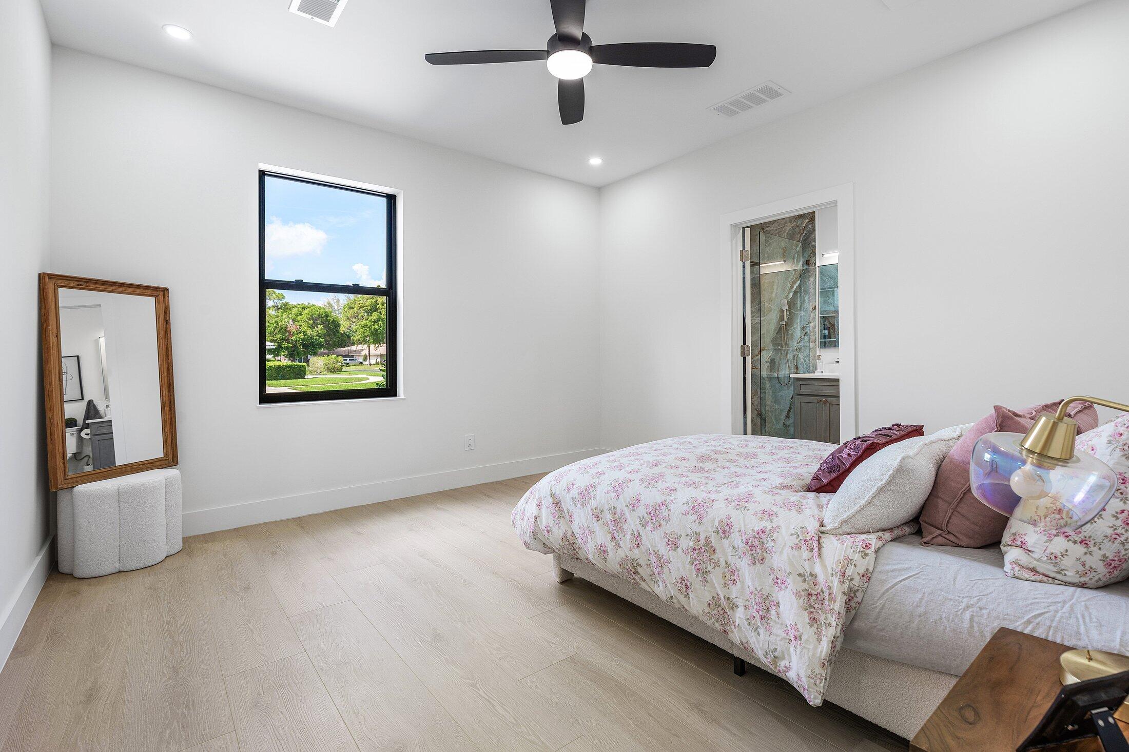 6901 Giralda Circle Boca Raton, FL 33433 - Photo 46 of 83 a bedroom with a bed and a chandelier