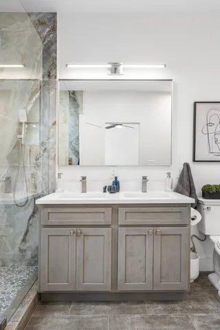 an aerial view of residential houses with outdoor space and trees