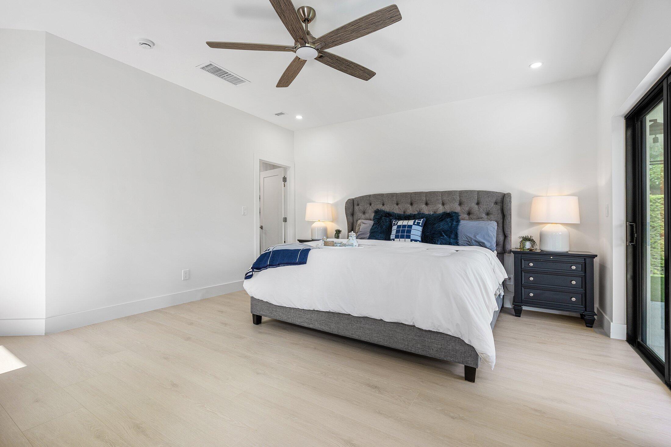 6901 Giralda Circle Boca Raton, FL 33433 - Photo 52 of 83 a bedroom with a bed and a ceiling fan