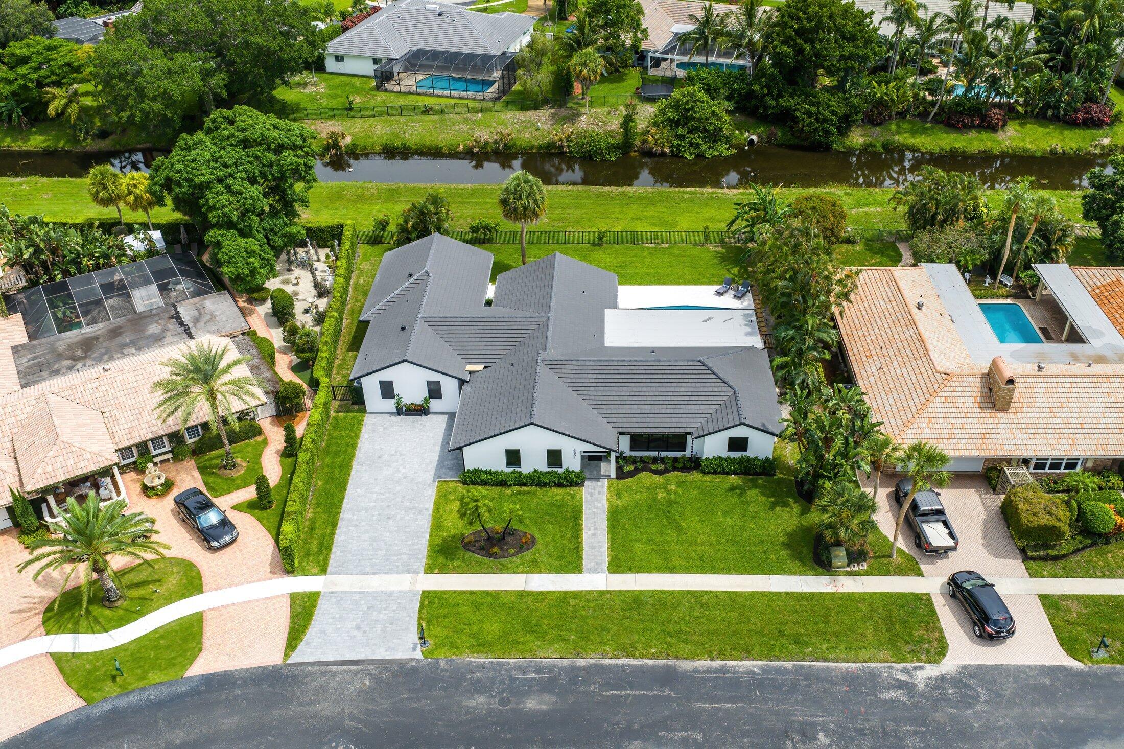 6901 Giralda Circle Boca Raton, FL 33433 - Photo 72 of 83 an aerial view of a house with a garden and trees
