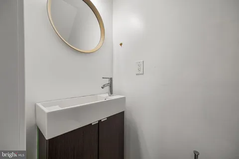 a bathroom with a sink a vanity and a mirror