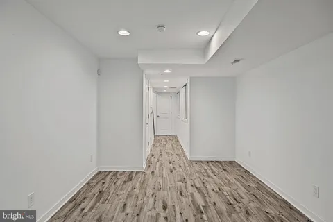 a view of an empty room and wooden floor