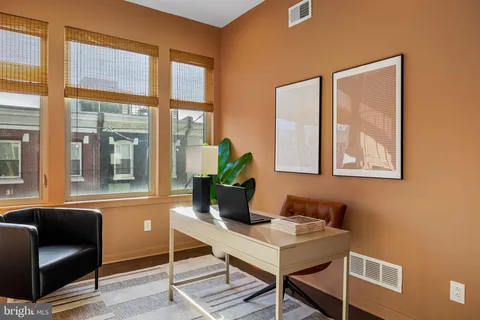 a living room with furniture and a potted plant