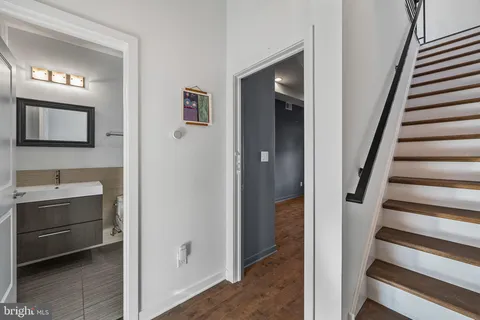 a view of a hallway to rooms and stairs