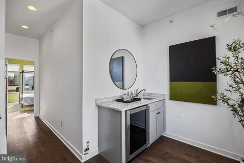 a kitchen with a sink and a mirror