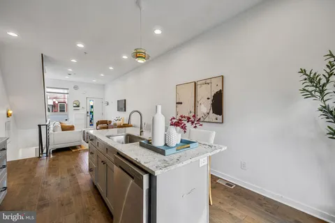 a view of living room with furniture and wooden floor