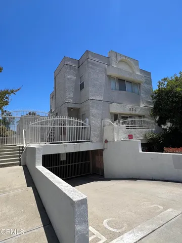 a view of roof deck with couches and sky view