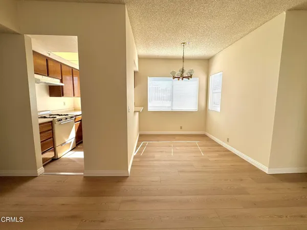 a view of a kitchen with a refrigerator cabinets and a wooden floor