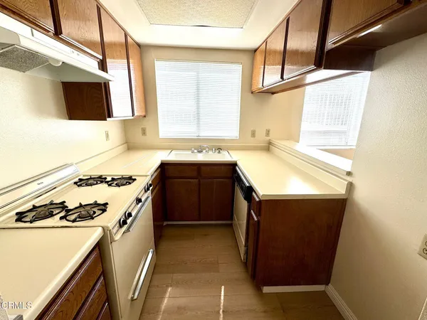 a kitchen with a stove sink and a microwave