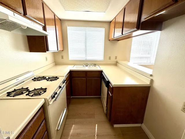 a kitchen with a stove sink and a microwave