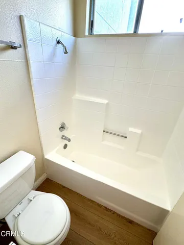 a bathroom with a toilet and a bathtub