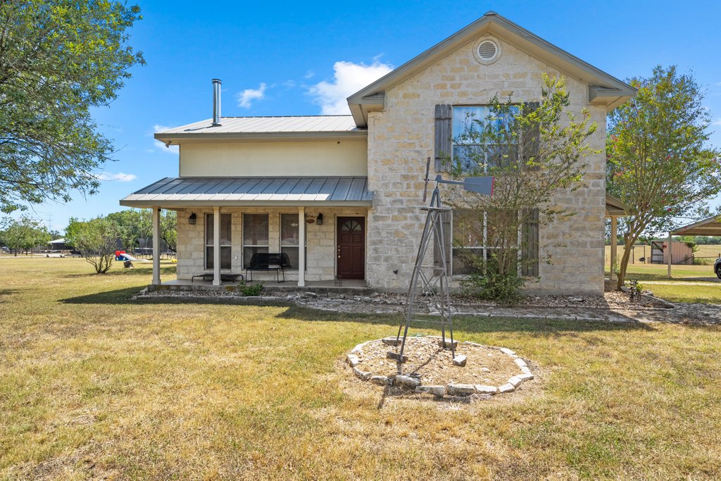 a view of a house with swimming pool and sitting area
