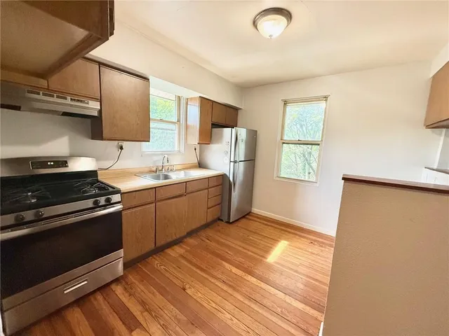 a kitchen with a sink appliances and cabinets