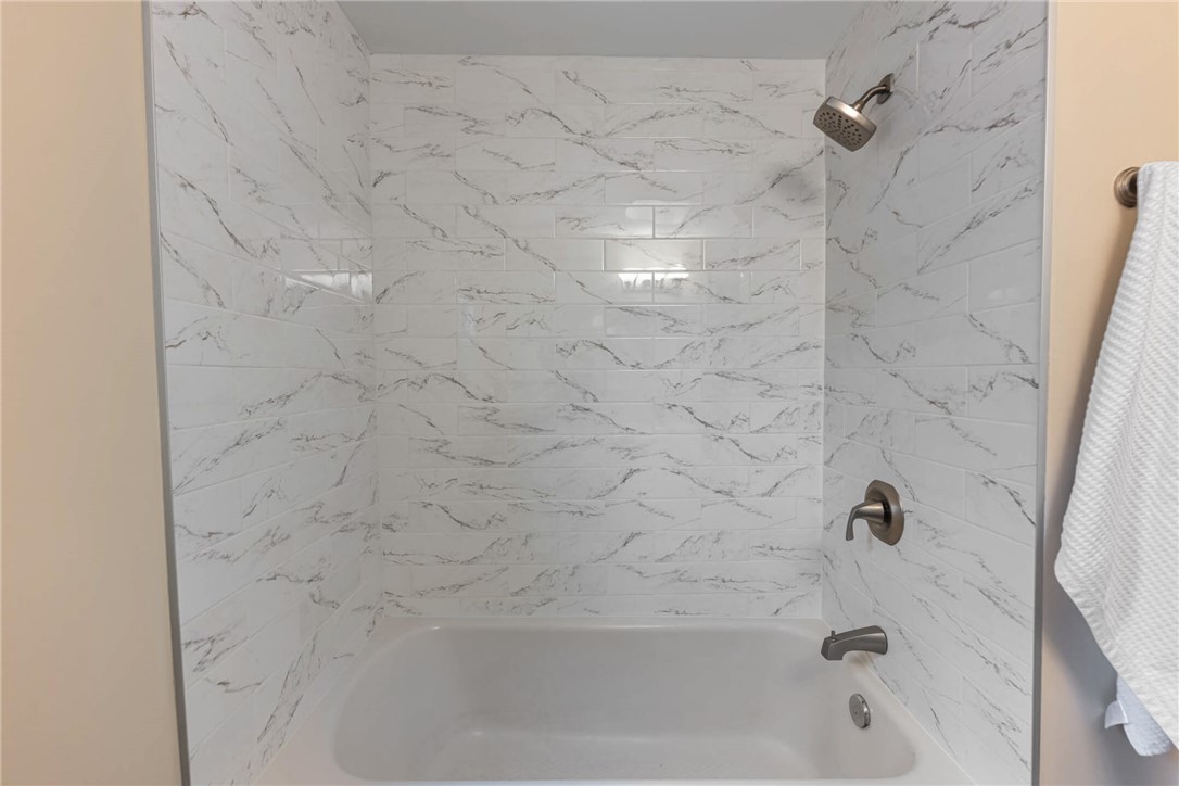 1012 Hampshire Road Dayton, OH 45419 - Photo 24 of 39 This bathroom showcases elegant tiled walls surrounding a classic bathtub.