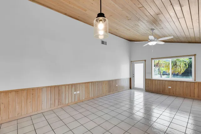 a kitchen with stainless steel appliances a kitchen island wooden cabinets and a chandelier