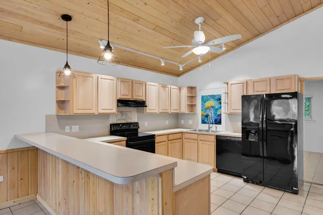 a kitchen with a stove sink and cabinets
