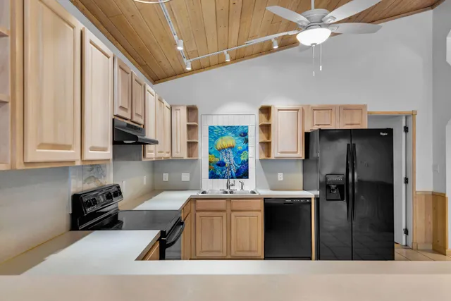 a kitchen with a sink stove and microwave