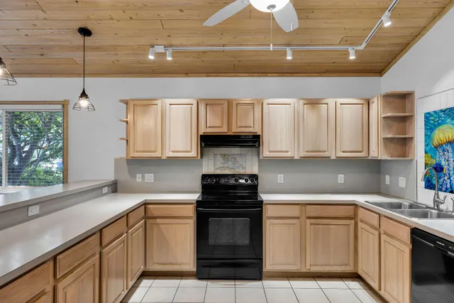 a kitchen with cabinets and window