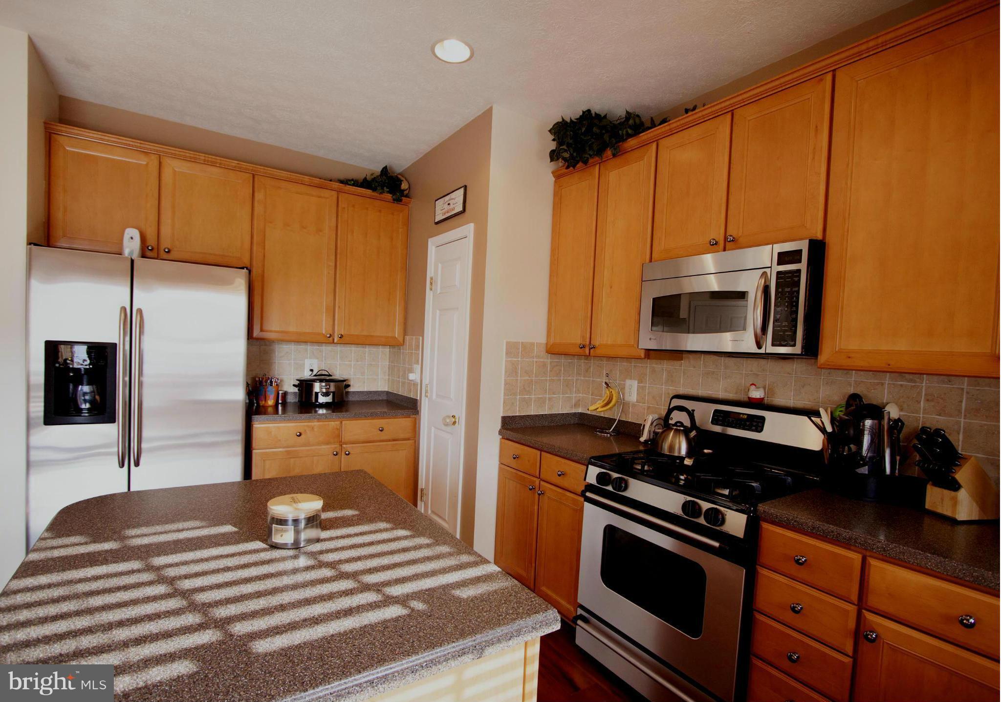 9653 Biggs Road Baltimore, MD 21220 - Photo 2 of 22 a kitchen with stainless steel appliances granite countertop a stove a sink and a microwave