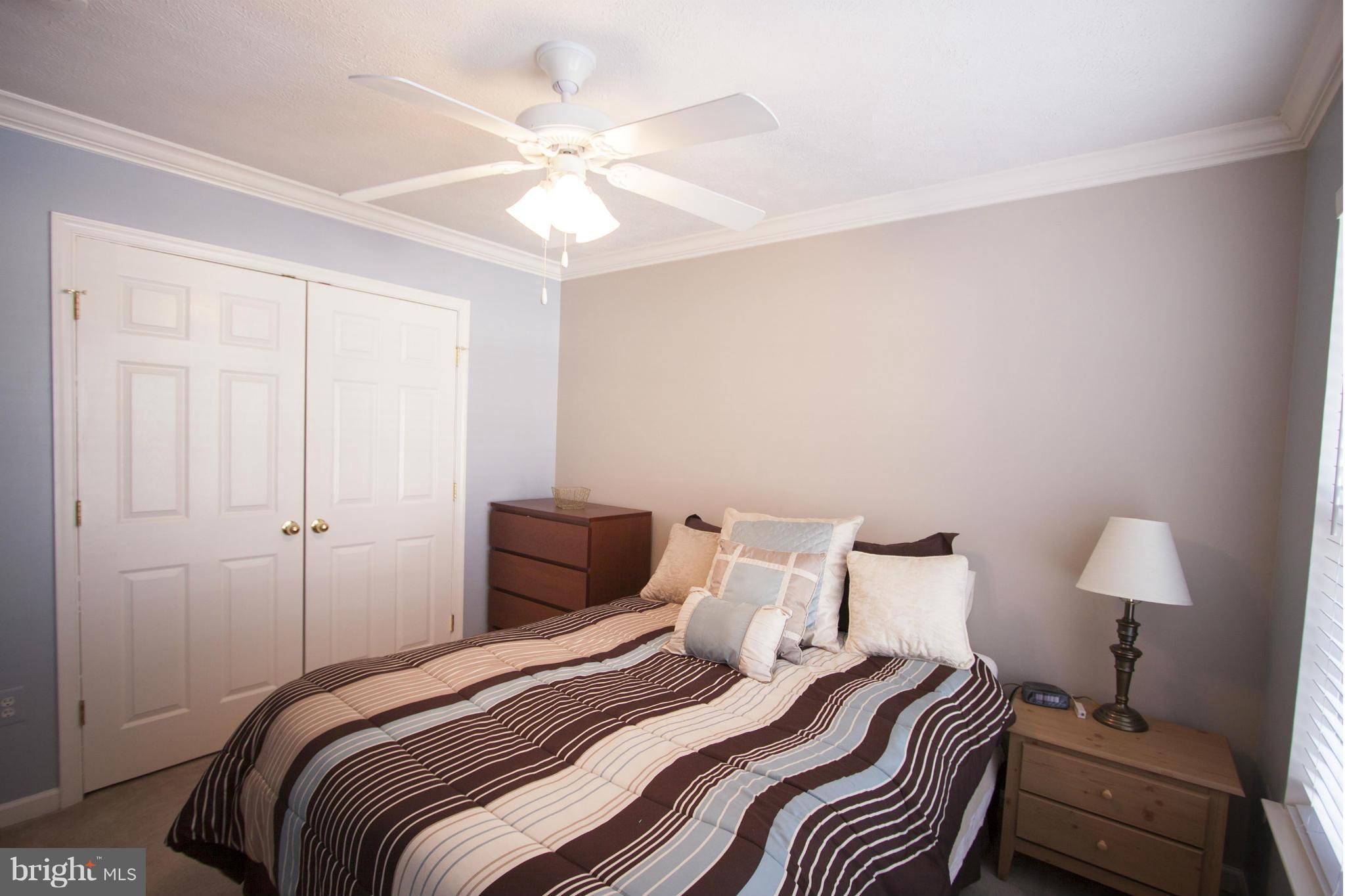 9653 Biggs Road Baltimore, MD 21220 - Photo 9 of 22 a bedroom with a bed and a lamp