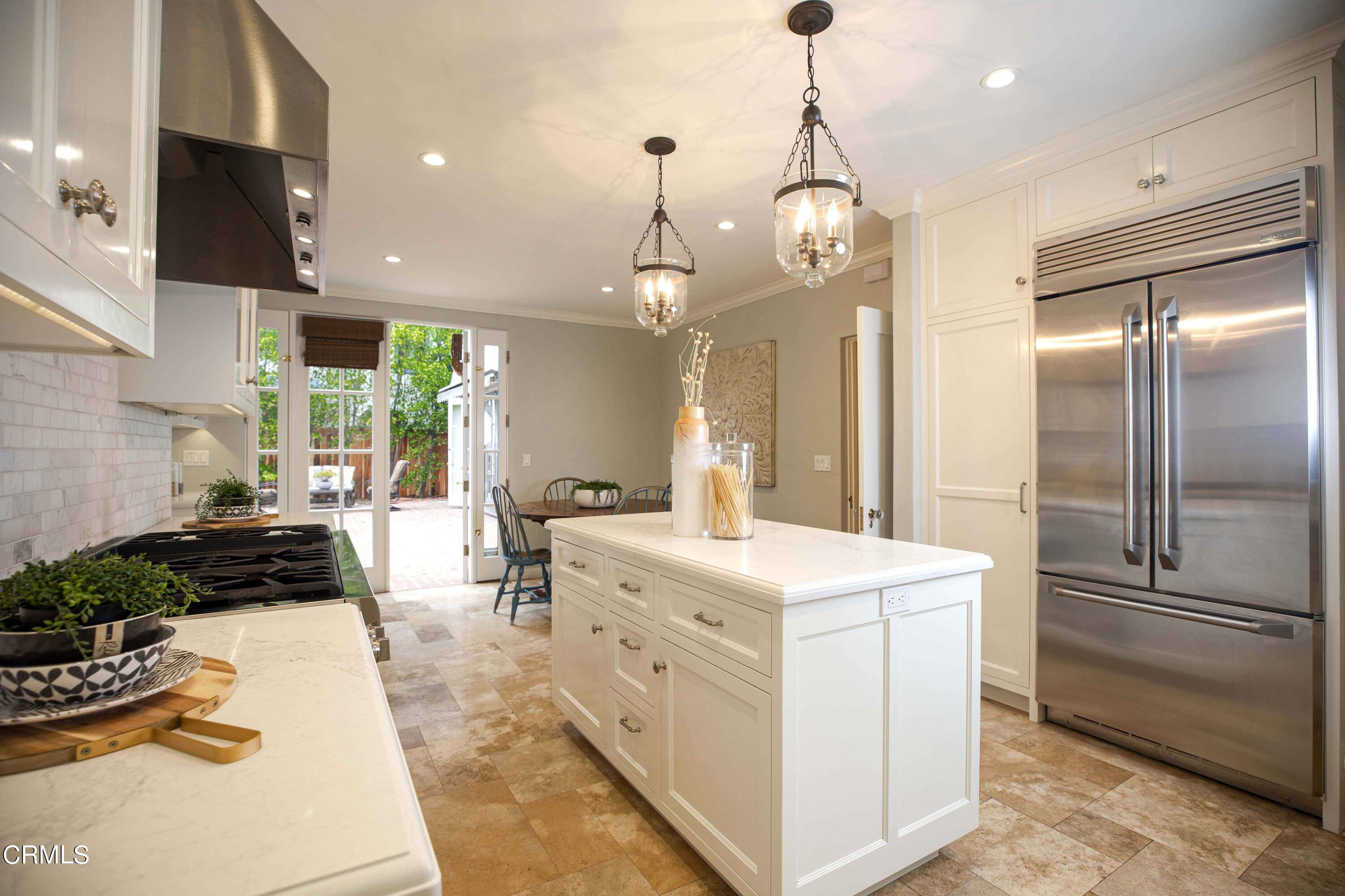 Undisclosed Address Pasadena, CA 91106 - Photo 13 of 40 a kitchen that has a lot of white cabinets and stainless steel appliances