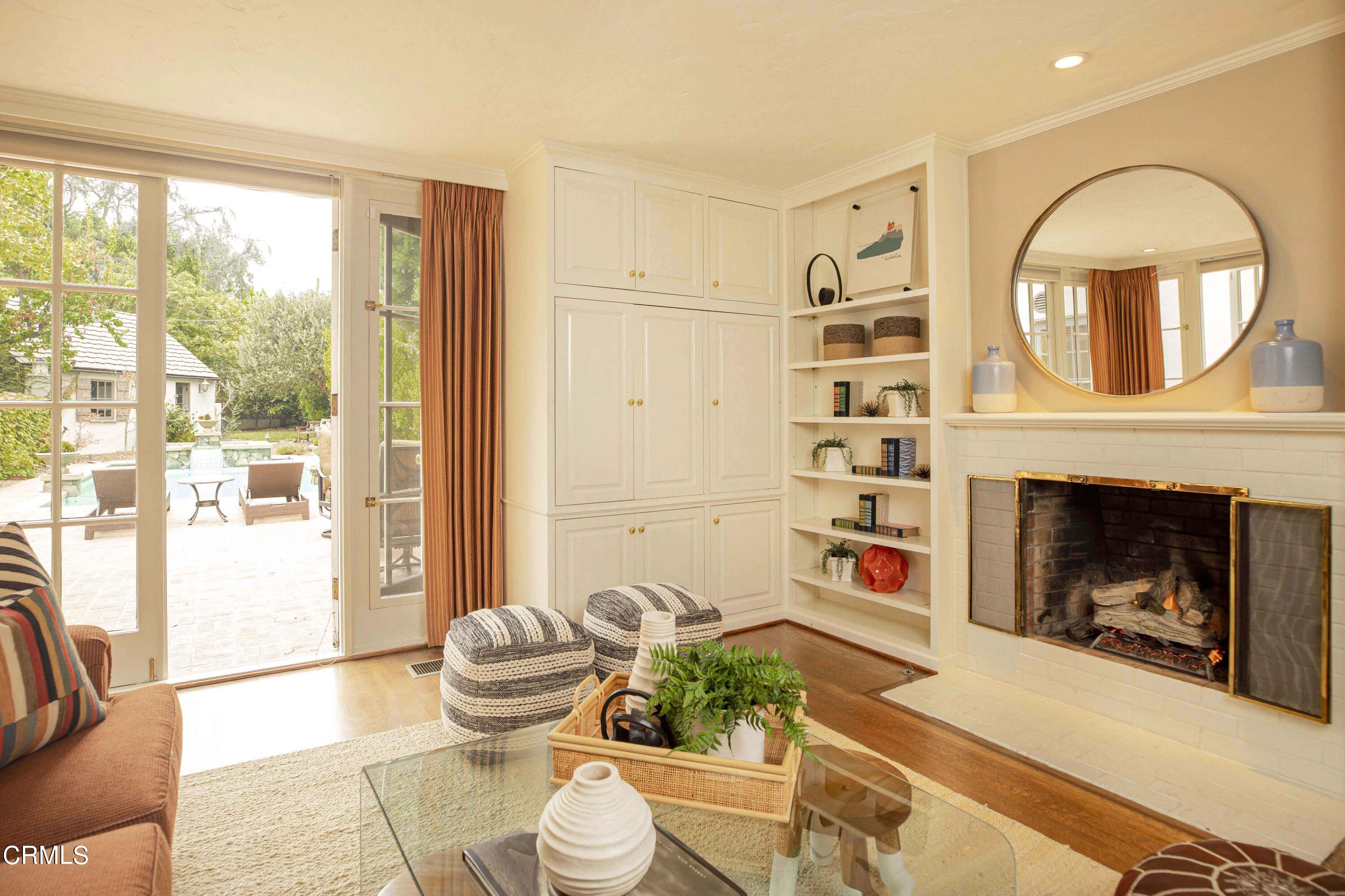 Undisclosed Address Pasadena, CA 91106 - Photo 20 of 40 a living room with furniture a fireplace and a large window